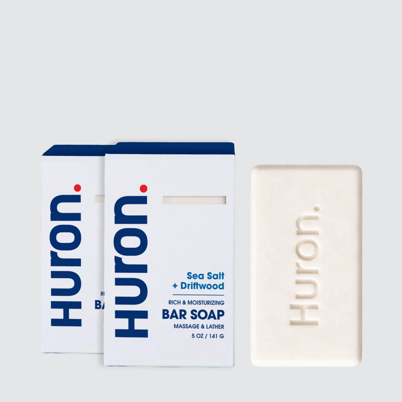 Front view of Huron Sea Salt + Driftwood 2-pack and 5 oz bar showing embossed Huron logo and packaging on light gray background