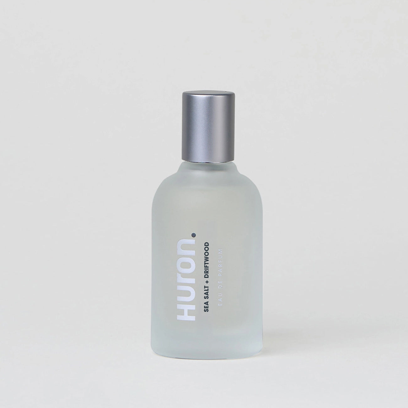 Huron perfume bottle labeled 'SEA SALT + DRIFTWOOD EAU DE PARFUM' with silver cap on a plain background
#scent_sea salt + driftwood