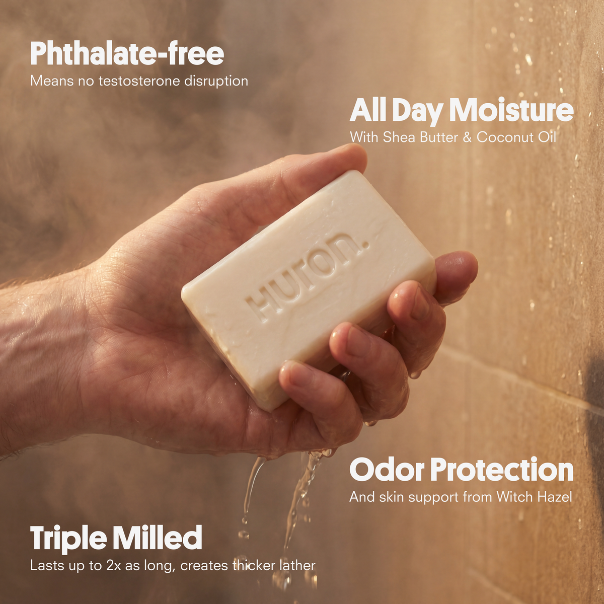 Hand holding HUTON. soap bar in shower; overlay text: Phthalate-free; All Day Moisture; Odor Protection; Triple Milled.