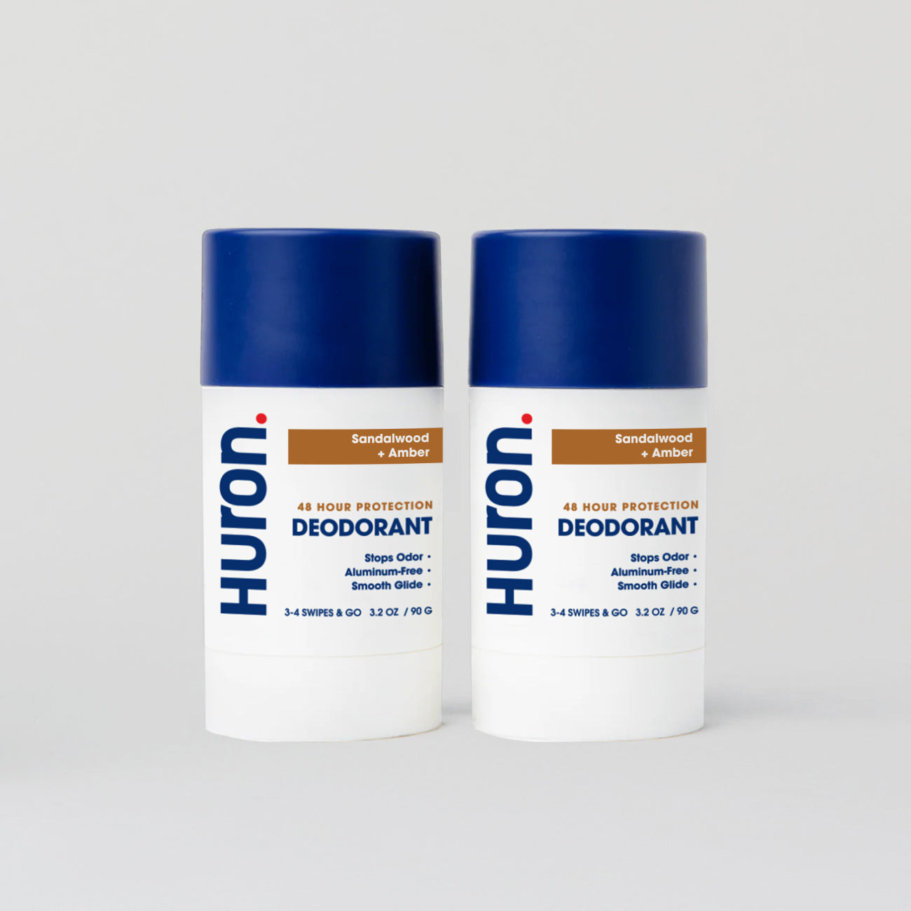 Two Huron deodorant sticks with blue caps, Sandalwood + amber scent #scent_sandalwood + amber