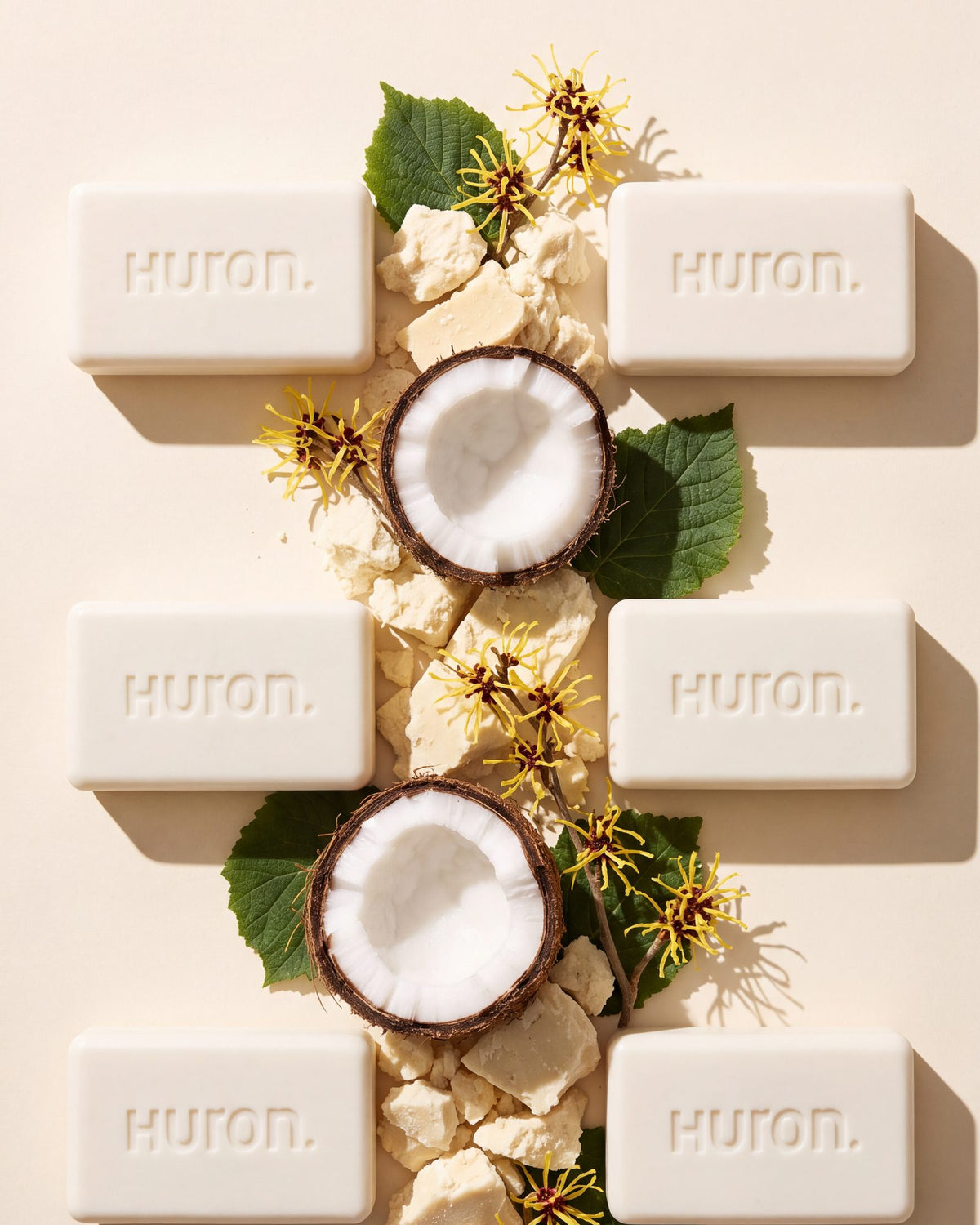 Two columns of three Huron bars with shea butter, coconut and witch hazel between them