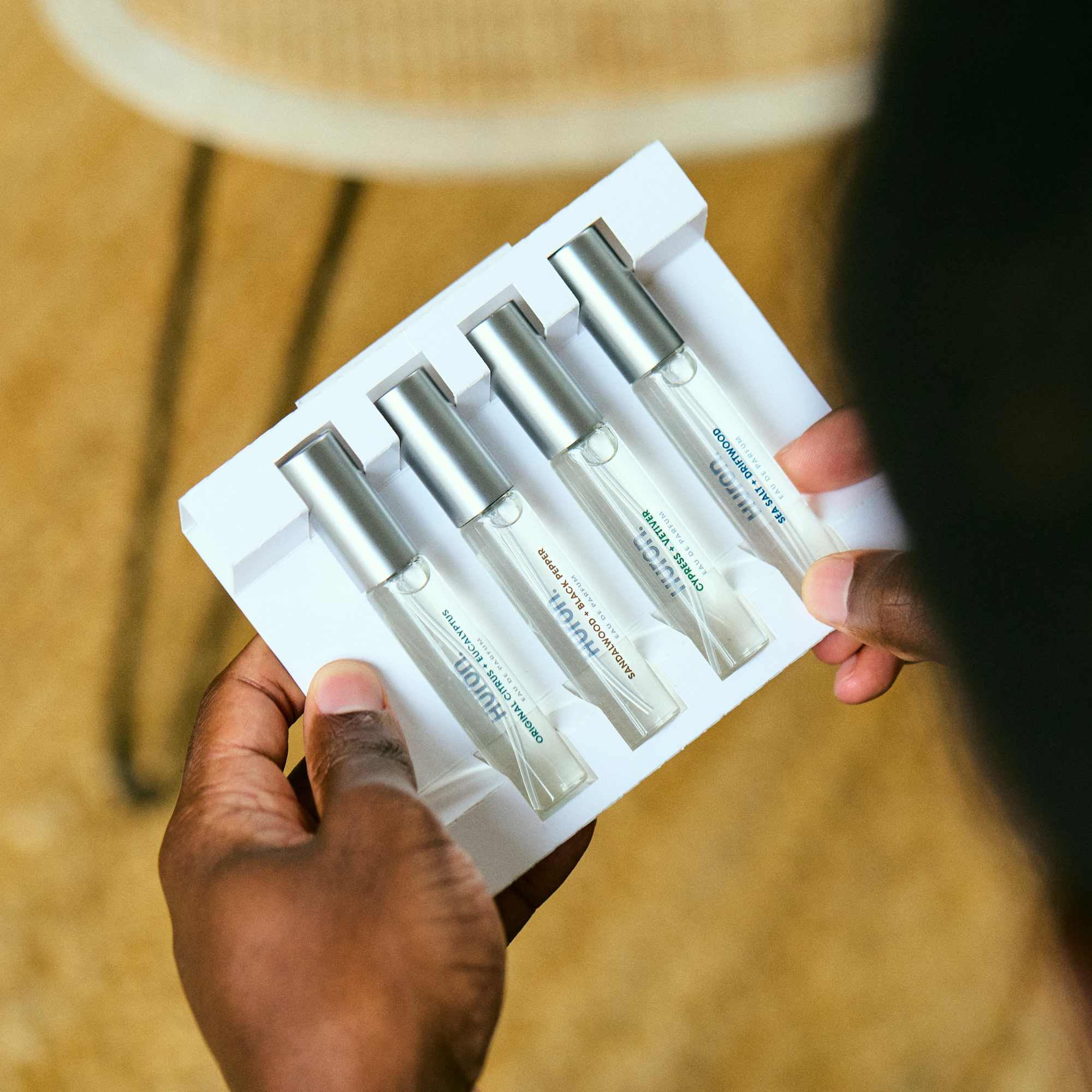 Person holding the Best Smellers Set with four perfume vials in a box
