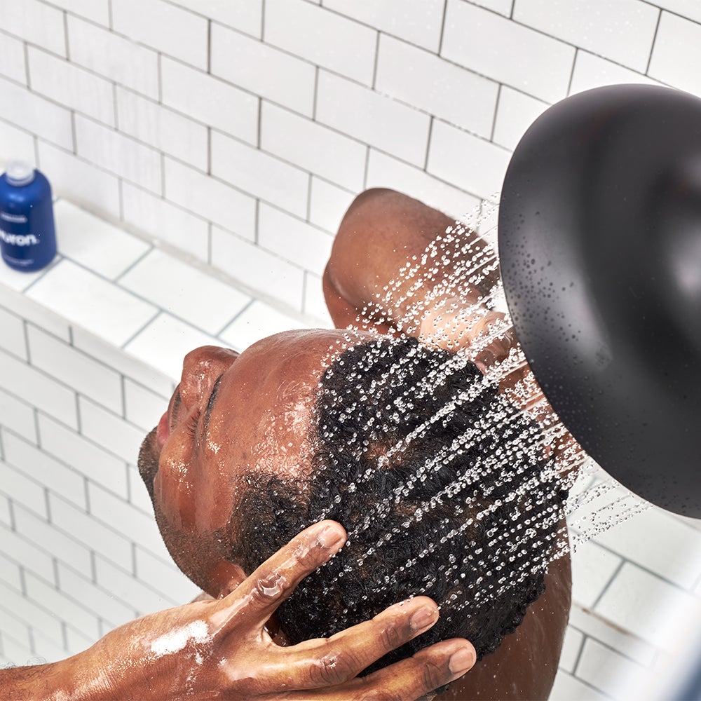 Man using conditioner in the shower, product bottle visible: Conditioner for Men
