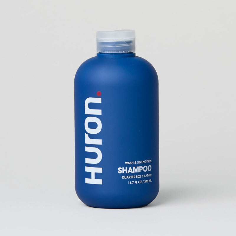 Blue shampoo bottle labeled 'Huron Shampoo' with 12 fl oz size