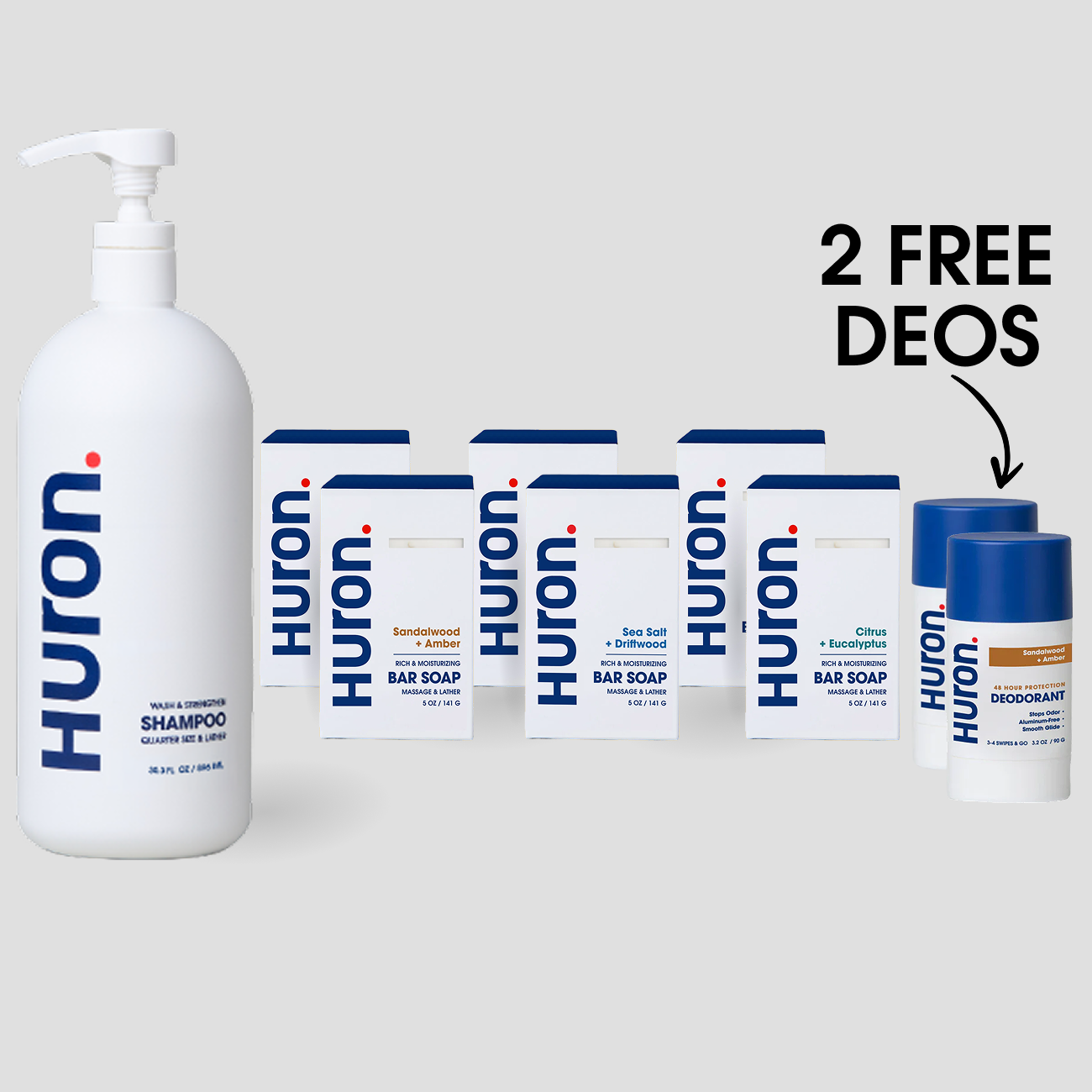 Front view of Huron shower set with jumbo shampoo, six bar soaps, and two deodorants; image text: 2 FREE DEOS