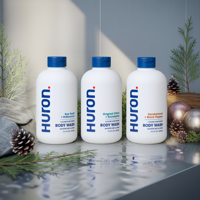 Three Huron body wash bottles: Sea Salt + Driftwood; Original Citrus + Eucalyptus; Sandalwood + Black Pepper