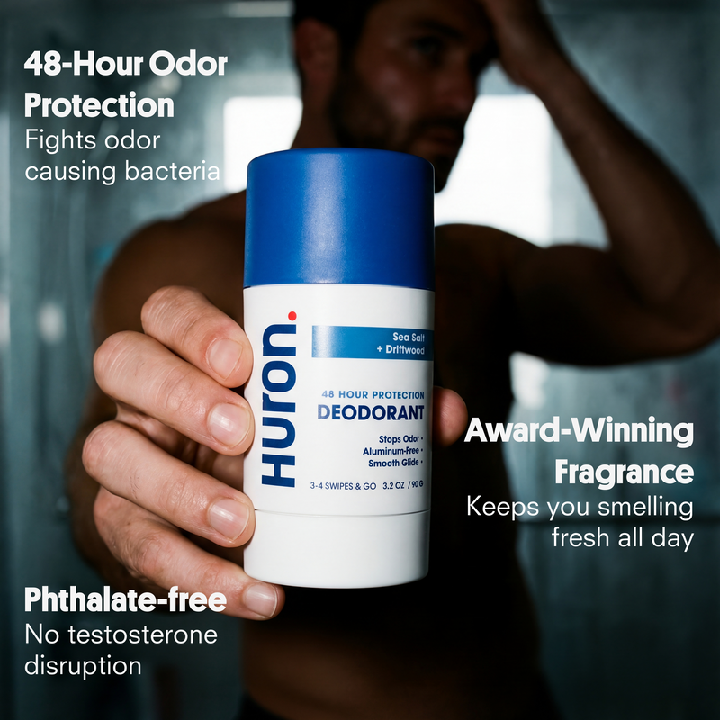 Man holding Huron Sea Salt + Driftwood deodorant; label reads 48 HOUR PROTECTION DEODORANT.