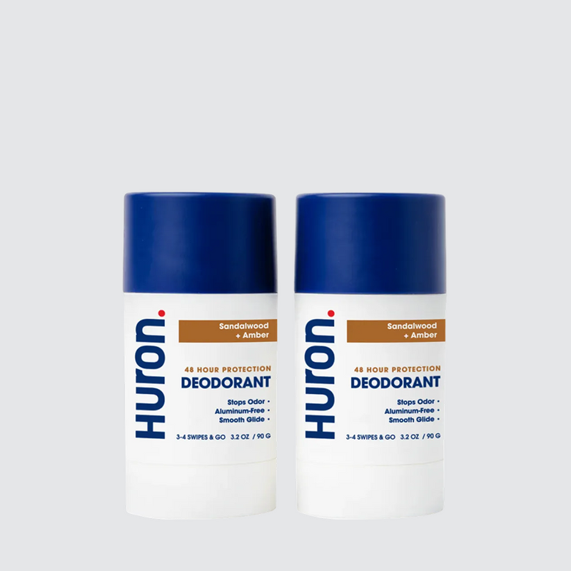 Two Huron deodorant sticks with blue caps, Sandalwood + amber scent #scent_sandalwood + amber