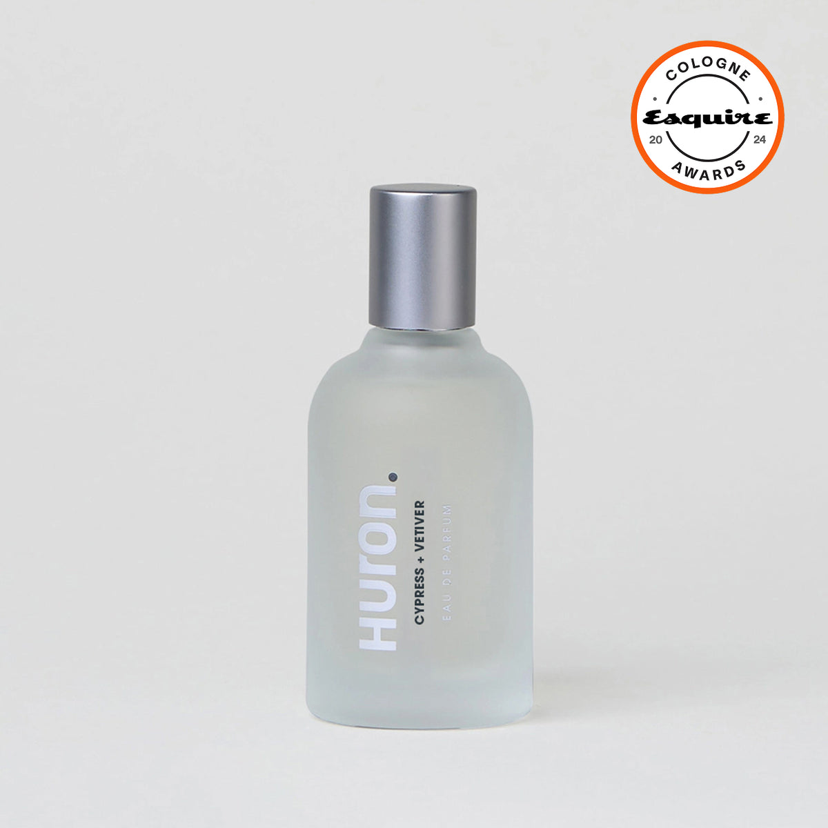 Frosted glass bottle of Huron cologne with text 'CYPRESS + VETIVER EAU DE PARFUM' and silver cap, with Esquire Cologne Awards 2024 badge #scent_cypress + vetiver