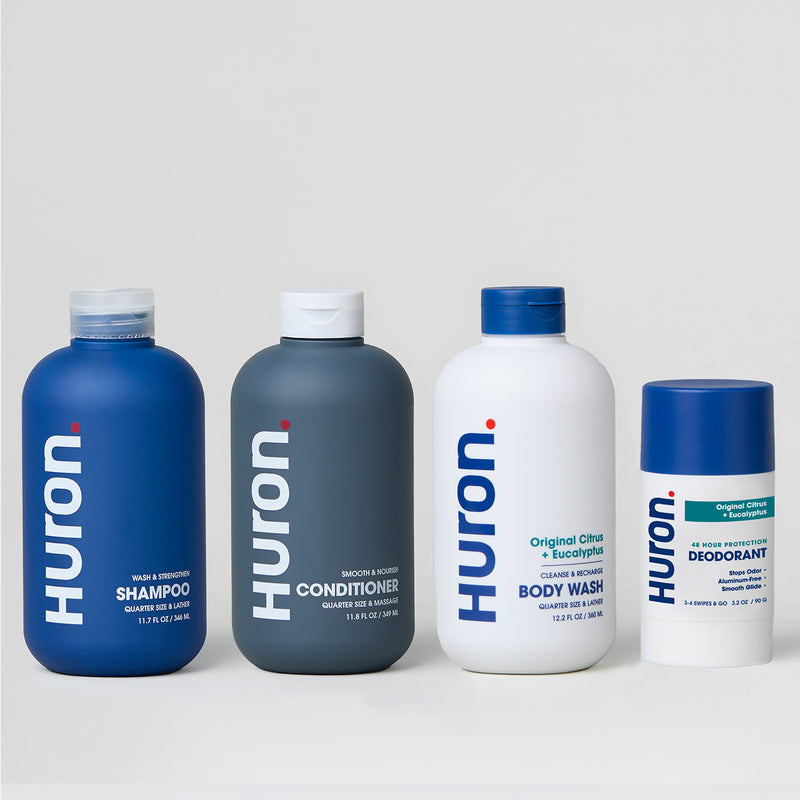 Four Huron personal care products: shampoo, conditioner, body wash, and deodorant.#scent_citrus + eucalyptus