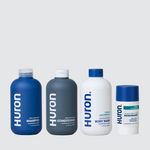 Four Huron bottles: SHAMPOO; CONDITIONER; BODY WASH (Citrus + Eucalyptus); DEODORANT. #scent_citrus + eucalyptus