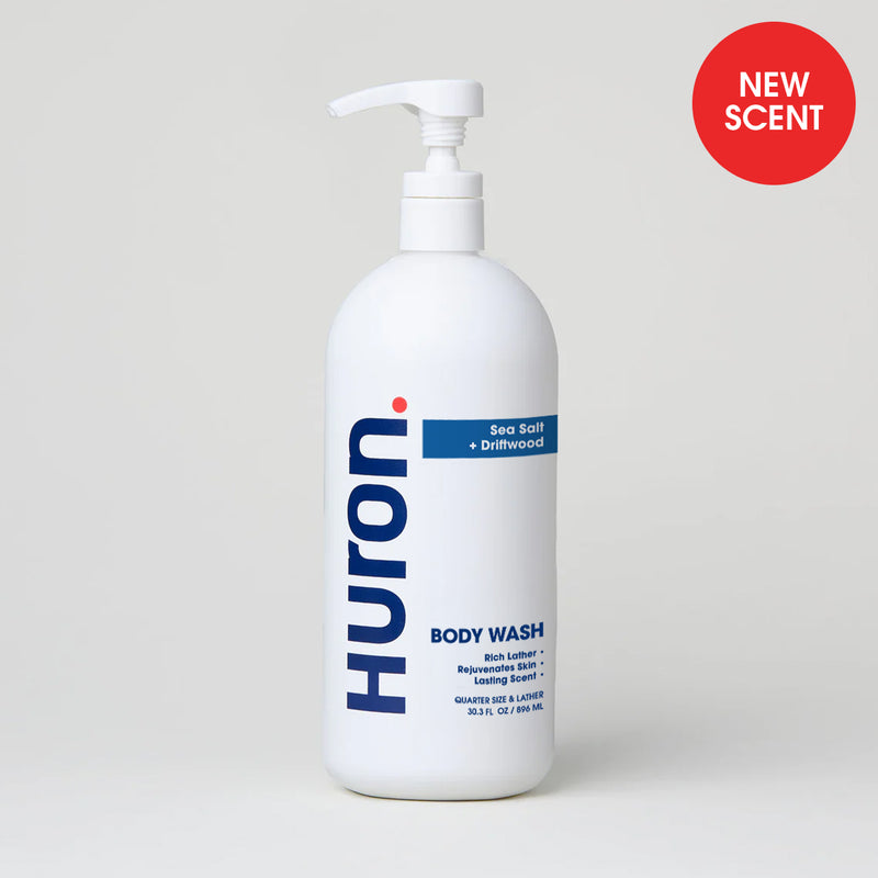 Huron Body Wash in Sea Salt + Driftwood scent with pump dispenser, labeled 'NEW SCENT'#scent_sea salt + driftwood
