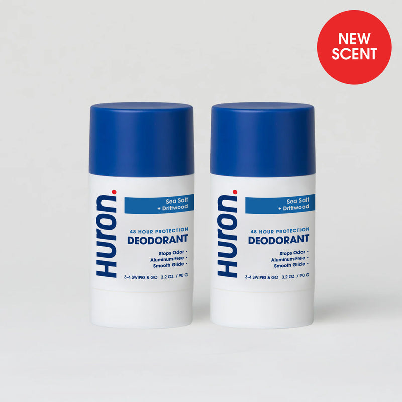 Two Huron deodorant sticks with blue caps, Sea Salt + Driftwood scent with a NEW SCENT badge #scent_sea salt + driftwood
