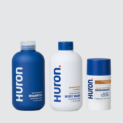 Three HURON products: SHAMPOO; BODY WASH; DEODORANT — Sandalwood + Amber, 48 HOUR PROTECTION.
