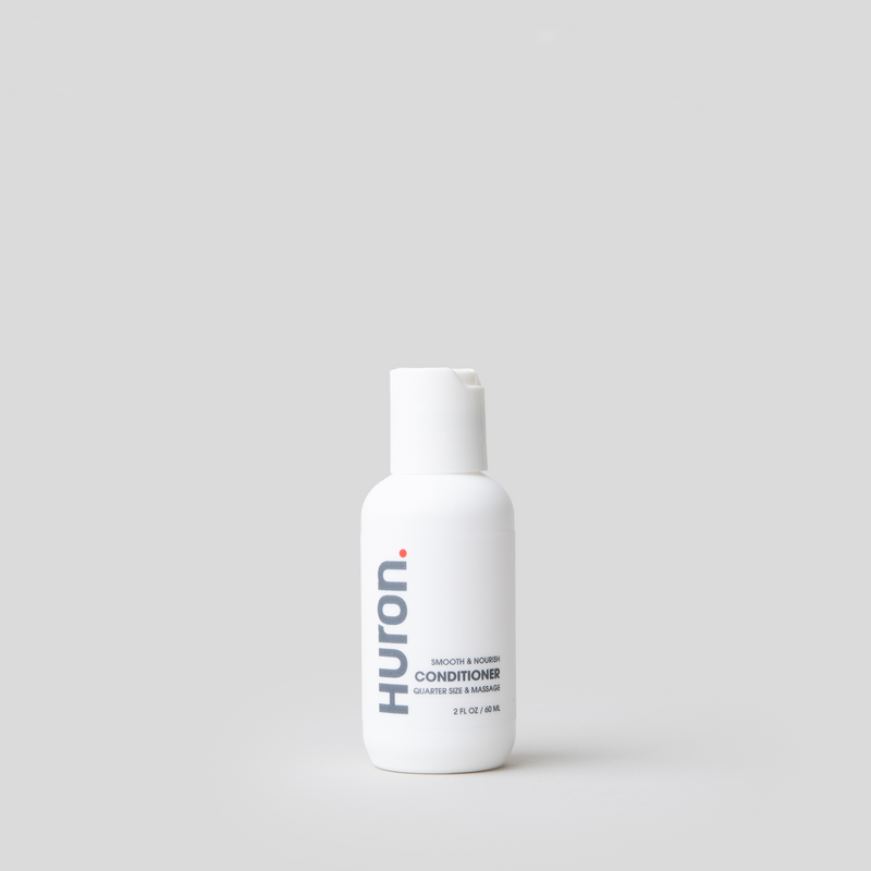 Huron Conditioner Travel Size bottle on a gray background