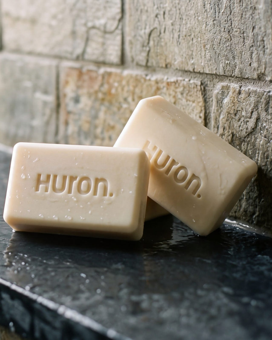 Two Huron bars set down on a slate shower ledge