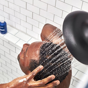 Man in shower using sulfate free conditioner for men. Great for curly hair